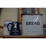 An old enamel breadbin and cover; together with a large Whitbread tankard; and one other item.