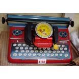 A vintage Mettype tinplate toy typewriter, in original box; together with a novelty Garfield