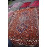 A Persian carpet, having three medallions and floral decoration to central field with geometric