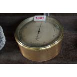 A brass aneroid barometer, the silvered dial inscribed 'T Wheeler, London, B32, 1937', with broad