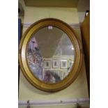 A gilt framed oval wall mirror, 62 x 52cm.