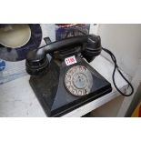 A vintage black Bakelite pyramid telephone.