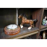 An oak ropetwist aneroid barometer; together with a Beswick Shire horse.