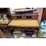 A reproduction mahogany desk, on reeded legs, 106cm wide.