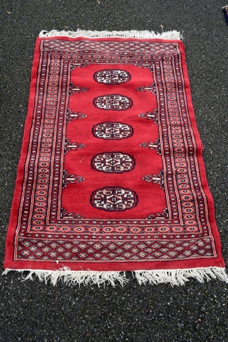 A Pakistani rug, having allover floral and geometric design on a red ground; together with a similar - Image 3 of 3