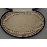 A single strand graduated pearl necklace, in fitted box, 38cm.