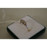 An 18ct yellow and white gold diamond three stone ring, total weight 3.3g.