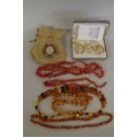 Three amber style necklaces; together with a coral branch necklace and bracelet; and three other