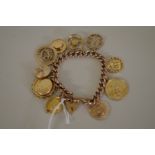 A 9ct gold chain having twelve charms attached, including a gold sovereign; one marked 750; four
