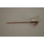 An unmarked natural pearl and solitaire diamond stickpin, 6cm.