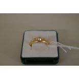 An 18ct gold three stone diamond gypsy set ring, 6.9g all in.