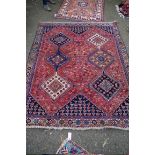 A Persian rug, having six floral and geometric medallions to central field and floral and bird