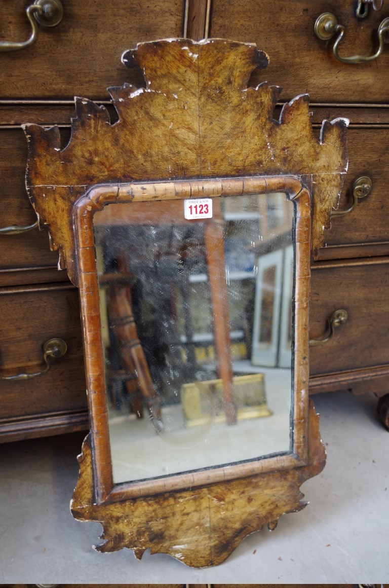 An antique walnut and faux grained wall mirror, 66.5 x 38.5cm, impressed markings verso.