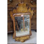 An antique walnut and faux grained wall mirror, 66.5 x 38.5cm, impressed markings verso.