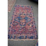 A Persian rug, having central floral medallion with geometric and floral border; together with