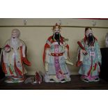 Three Chinese famille rose figures, The Emperor 38.5cm high.