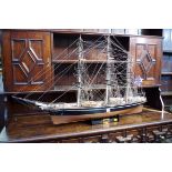A wood model of the 'The Cutty Sark', total length 114cm, on stand.