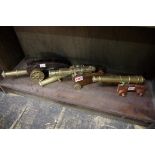 Four various brass desk cannons, three with carriage stands, largest cannon 23cm long.