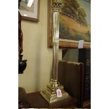A large polished brass Corinthian table lamp, 62cm high.