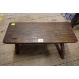 An antique oak low stool, 49cm wide.