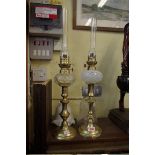 A pair of small brass oil lamps.