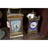 Two brass and enamel carriage timepieces, one with porcelain panels, largest 20cm high.