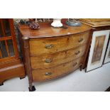 A Regency mahogany bowfront chest, of three long drawers, with reeded outset pilasters, 104cm wide.