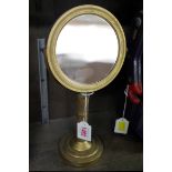 An antique gilt brass shaving type mirror, 31cm high.