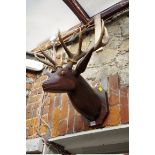 A Folk Art carved and painted wood stag's head, with a pair of natural ten pointed antlers.