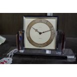 An Art Deco chrome timepiece, by Smiths, 16cm wide.