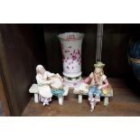 A Meissen spill vase, 14.5cm high; together with a pair of Continental pottery figures.