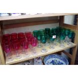A collection of seventeen green wine glasses; together with sixteen similar cranberry examples,