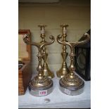 A pair of brass and polished steel fire iron rests; together with a pair of Victorian brass