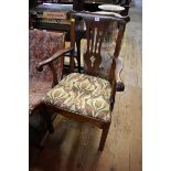 An 18th century oak elbow chair.