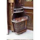 A late Victorian carved oak small hanging corner cupboard, 75cm high.