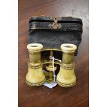 A pair of Victorian ivory and gilt brass opera glasses, in leather case.