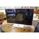 A Panasonic TX-L42E6B television, with remote control, (light surface scratches to screen).