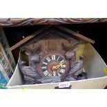 An old cuckoo clock, with pine cone weights and pendulum.