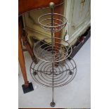 A wrought iron graduated three tier tripod stand, 70cm high.