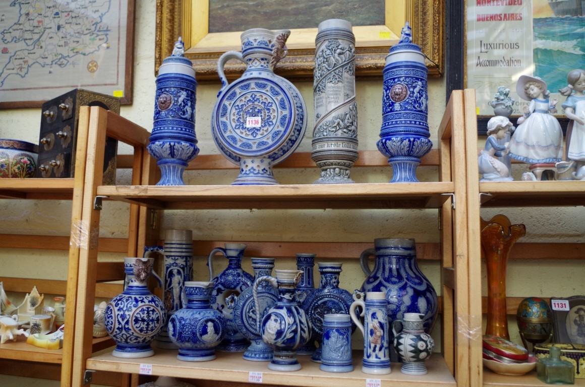 A collection of German salt glazed pottery jugs and vases, largest 37.5cm high. (2 shelves)