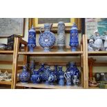 A collection of German salt glazed pottery jugs and vases, largest 37.5cm high. (2 shelves)