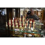 A late 19th century bone chest set, red stained and natural, king 9.1cm, pawn 3.5cm.