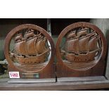 A pair of carved and pierced bookends, bearing plaque inscribed 'From the teak of the HMS Iron