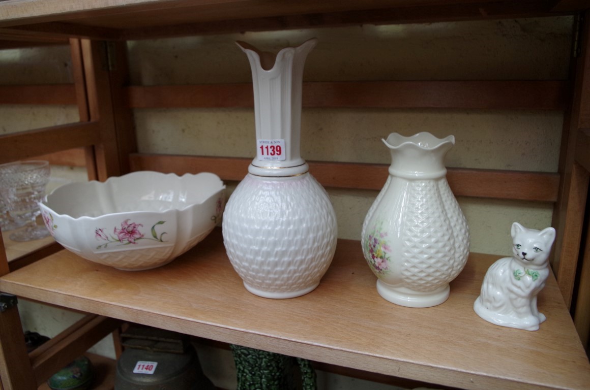 Three items of Belleek, largest 27cm high; together with a similar Donegal vase.