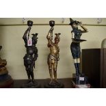 Two spelter figural knight candlesticks, 38cm high; together with another painted metal figure of
