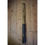 An old lacquered brass and black leather two drawer telescope, total length 85cm.