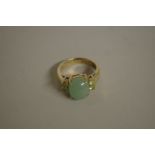 A gold plated ring set cabochon green stone, stamped .925.