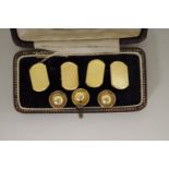 A cased pair of 18ct gold engine turned cufflinks; together with three 18ct gold studs, 11g.