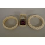 Two ivory bangles; together with a 19th century ivory ring box. (3)