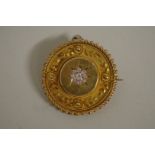 A Victorian circular memento mori brooch, the centre set diamonds, having glass back, 3cm